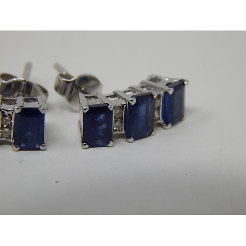 104 - Sapphire and diamond earrings, three rectangular cut sapphires vertically set with two round brillia... 