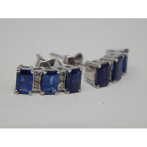 104 - Sapphire and diamond earrings, three rectangular cut sapphires vertically set with two round brillia... 