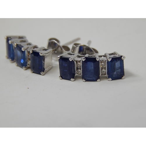 104 - Sapphire and diamond earrings, three rectangular cut sapphires vertically set with two round brillia... 