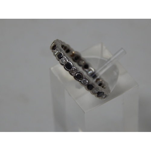 105 - Black and white diamond full eternity ring, alternating round cut black and white diamonds set in wh... 