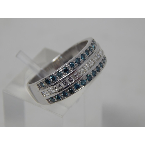 107 - Blue and white diamond three row ring, central row of white princess cut diamonds, with a row of blu... 