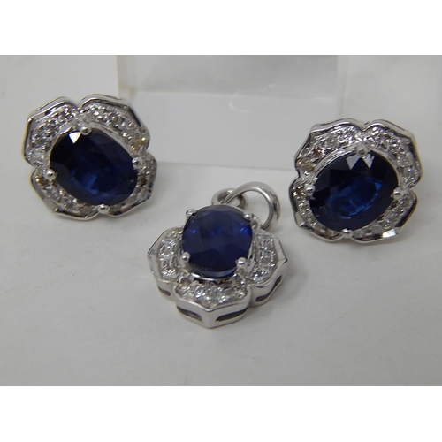 109 - Sapphire and diamond pendant, ring and earring set, each item set with an oval cut sapphire and a su... 