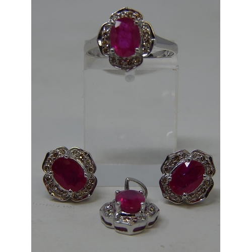 110 - Ruby and diamond pendant, ring and earring set, each item set with an oval cut ruby and a surround o... 