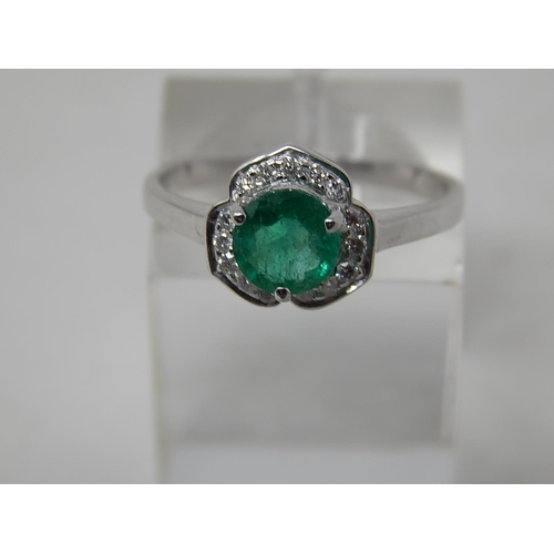 111 - Emerald and diamond pendant, ring and earring set, each item set with a round cut emerald and a surr... 