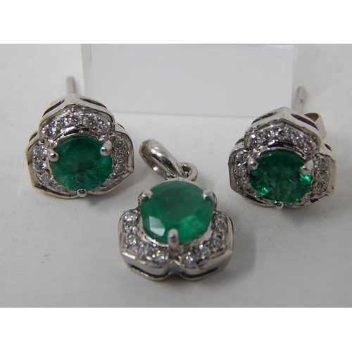 111 - Emerald and diamond pendant, ring and earring set, each item set with a round cut emerald and a surr... 