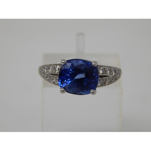 112 - Sapphire and diamond dress ring, central cushion cut sapphire weighing an estimated 3.00cts, four cl... 