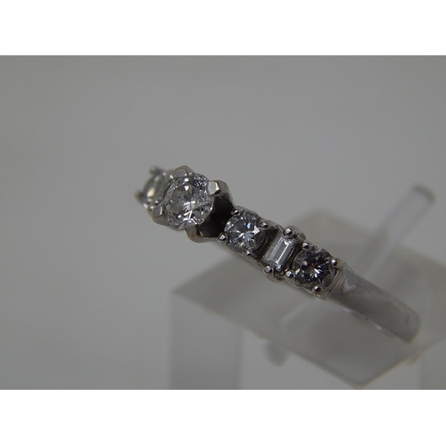 115 - 18ct White Gold Ring Inset with a central diamond flanked either side by three further diamonds. Rin... 