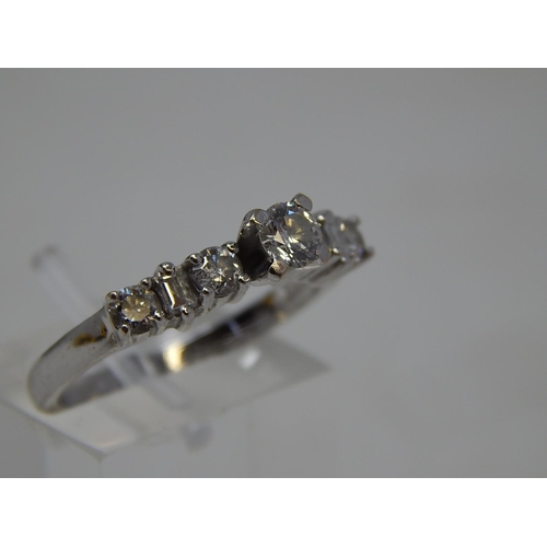 115 - 18ct White Gold Ring Inset with a central diamond flanked either side by three further diamonds. Rin... 