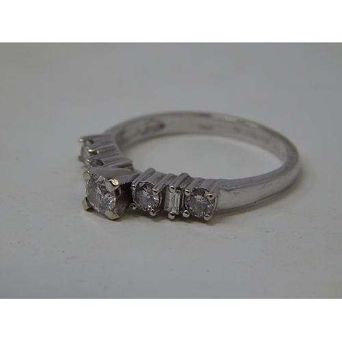 115 - 18ct White Gold Ring Inset with a central diamond flanked either side by three further diamonds. Rin... 