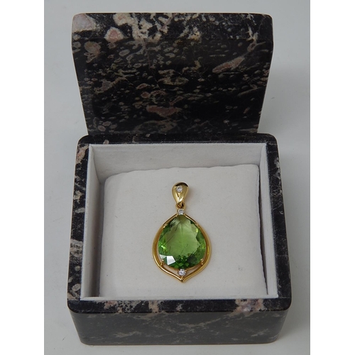 125 - Large Peridot & Diamond Pendant. Pear shaped Peridot weighing 23.82cts with a round brilliant cut di... 