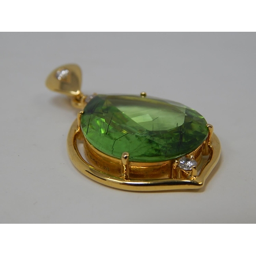 125 - Large Peridot & Diamond Pendant. Pear shaped Peridot weighing 23.82cts with a round brilliant cut di... 