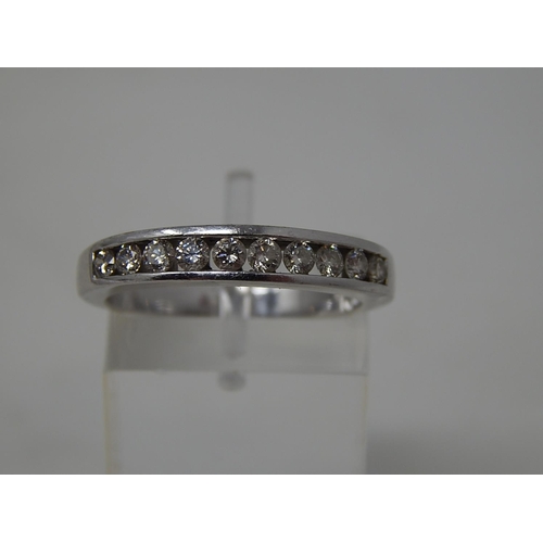 133 - 18ct White Gold Ring Inset with 10 Diamonds, Chanel Set. Ring Size O1/2