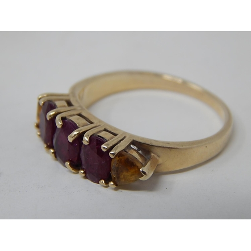 135 - Ruby and yellow sapphire five stone ring, three oval cut rubies with a trilliant cut yellow sapphire... 