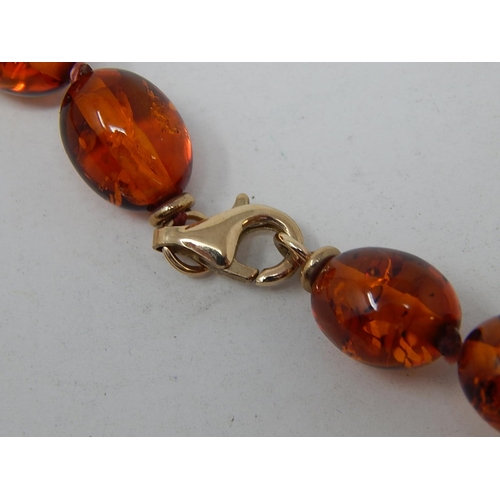 141 - Amber Necklace with 9ct Gold clasp. Measures 70cm Long.