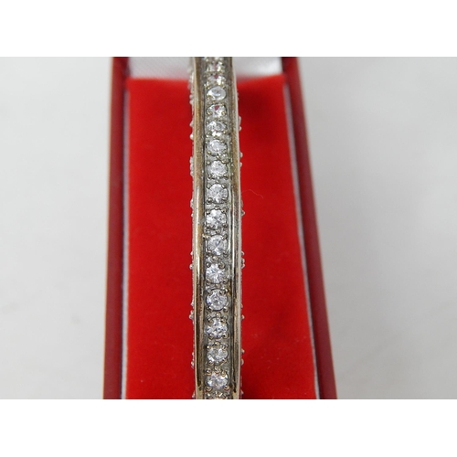 144 - Silver Hinged Bangle set with white stones: Internal diameter 5.5cm: Presented in Fitted Case.