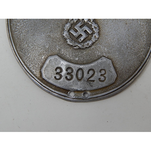 344 - WWII German Oval Shield with embossed party badge & stamped 33023. Measures 8cm x 6m5cm