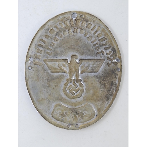 344 - WWII German Oval Shield with embossed party badge & stamped 33023. Measures 8cm x 6m5cm