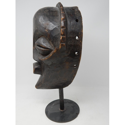 350 - Tribal Mask carved from one piece of wood on later Metal Stand: Measures 31cm high