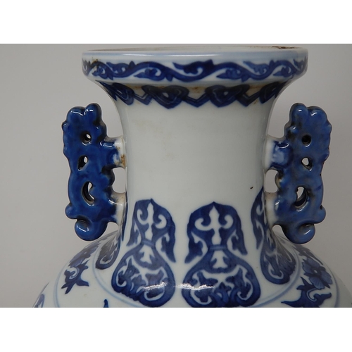 385 - Chinese blue and white porcelain vase, with twin handles raised on hardwood stand, the two central p... 