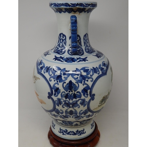 385 - Chinese blue and white porcelain vase, with twin handles raised on hardwood stand, the two central p... 