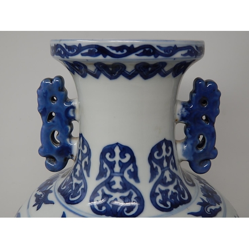 385 - Chinese blue and white porcelain vase, with twin handles raised on hardwood stand, the two central p... 