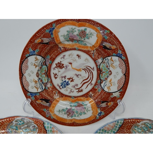 386 - Three Chinese porcelain plates including a pair hand painted with panels of dragons, the largest 22.... 