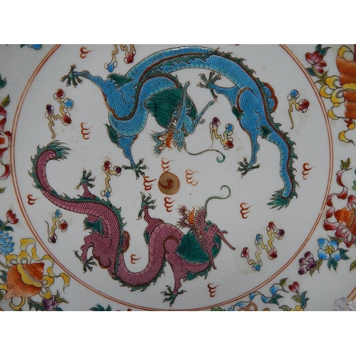 387 - WITHDRAWN: Chinese porcelain shallow dish, hand painted in the famille rose palette with objects and... 