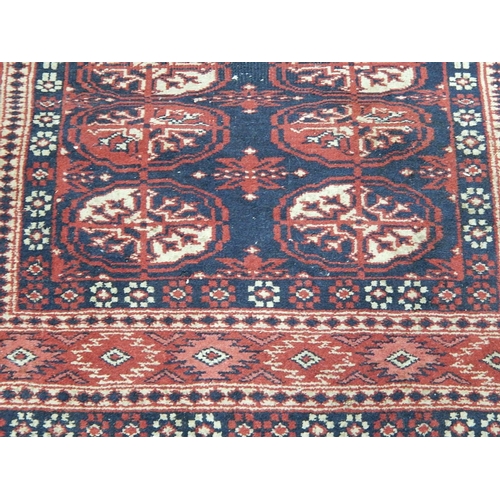 423 - Vintage Rug with Red Ground & Medallions: Size: 130cm x 95cm