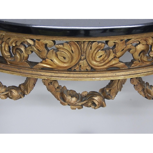 707 - 19th Century French Carved Giltwood Demi Lune Table with Black Granite Top. Measures 75cm high x 66c... 