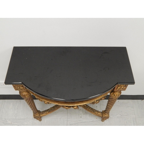 707 - 19th Century French Carved Giltwood Demi Lune Table with Black Granite Top. Measures 75cm high x 66c... 