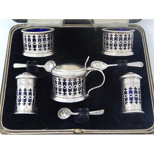 68 - Silver 5 Piece Cruet Set of Pierced Form with Blue Glass Liners. Hallmarked Birmingham 1932 within t... 