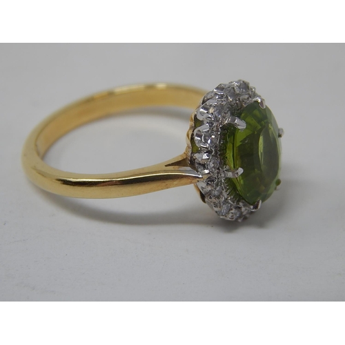 148 - Peridot and diamond cluster ring, oval cut peridot weighing an estimated 2.10cts, with a surround of... 