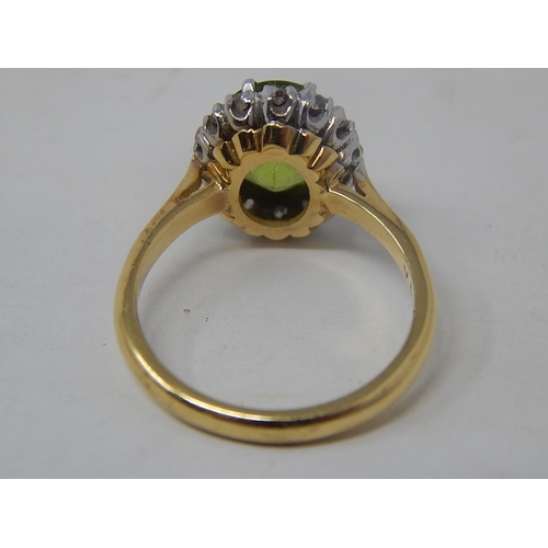 148 - Peridot and diamond cluster ring, oval cut peridot weighing an estimated 2.10cts, with a surround of... 