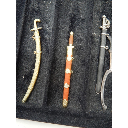 458 - Set of Fine Miniature Swords within their fitted Case: Together with paperwork.