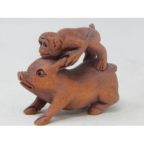 485 - CHINESE: Carved Wood Neksuke of a Monkey riding a Pig: Measures 5.4cm High