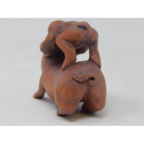 485 - CHINESE: Carved Wood Neksuke of a Monkey riding a Pig: Measures 5.4cm High