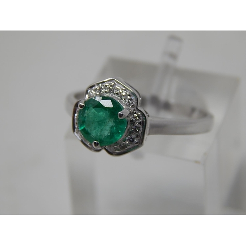 65 - Emerald and diamond pendant, ring and earring set, each item set with a round cut emerald and a surr... 