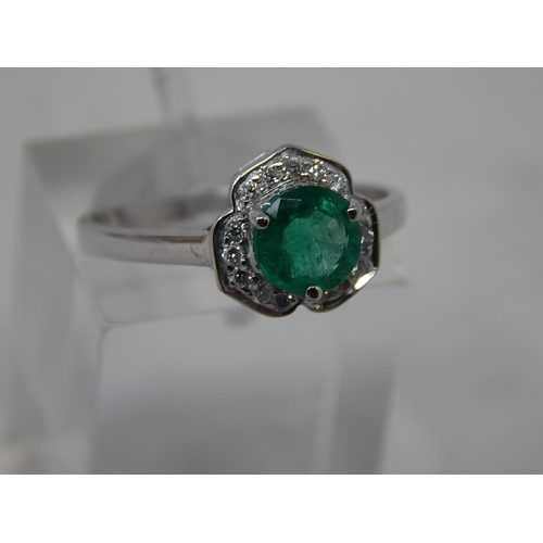 65 - Emerald and diamond pendant, ring and earring set, each item set with a round cut emerald and a surr... 