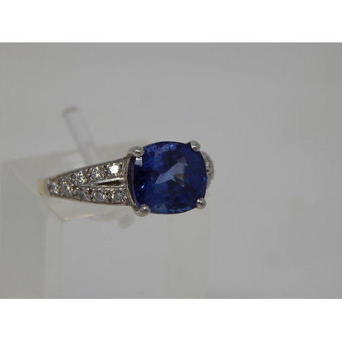 66 - Sapphire and diamond dress ring, central cushion cut sapphire weighing an estimated 3.00cts, four cl... 