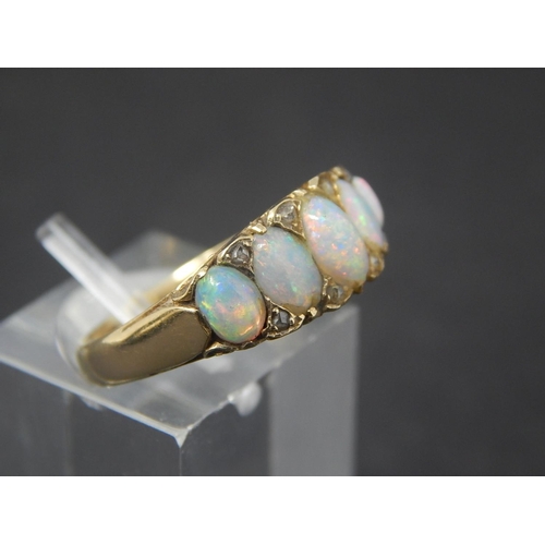 60 - Opal and diamond ring, five oval opals set with eight small rose cut diamonds in yellow metal stampe... 