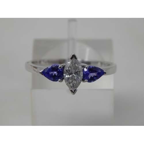 69 - Tanzanite and diamond three stone ring, central marquise cut diamond with a pear shaped tanzanite se... 