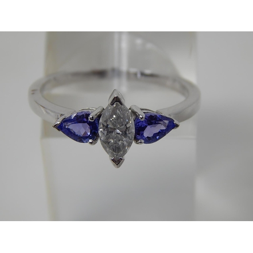 69 - Tanzanite and diamond three stone ring, central marquise cut diamond with a pear shaped tanzanite se... 