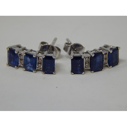 70 - Sapphire and diamond earrings, three rectangular cut sapphires vertically set with two round brillia... 