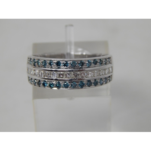 73 - Blue and white diamond three row ring, central row of white princess cut diamonds, with a row of blu... 