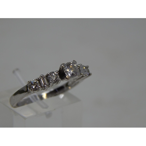 77 - 18ct White Gold Ring Inset with a central diamond flanked either side by three further diamonds. Rin... 