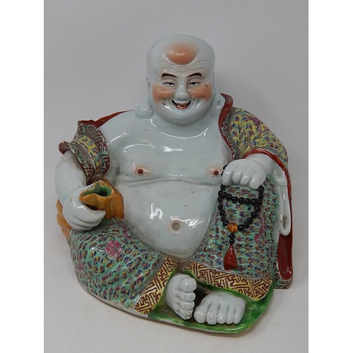 128 - Chinese porcelain figure of Buddha holding a sack, finely hand painted in the famille rose palette, ... 