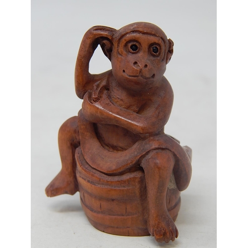 134 - CHINESE: Carved Wood Neksuke of a Monkey on a Barrel: Measures 5.2cm Wide