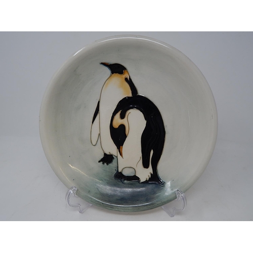 147 - A Moorcroft 'Penguin' plate, 25.7cm dia., impressed factory mark and date cypher, green painted mono... 