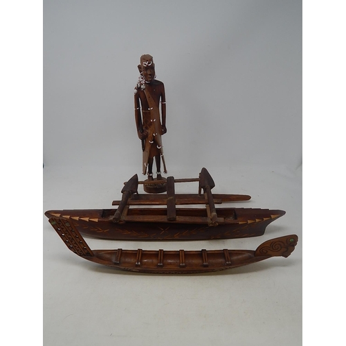 561 - Tribal Carved Wooden Figure 31cm: together with Two carved Wooden Boats 44cm & 37cm