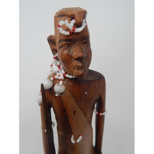 561 - Tribal Carved Wooden Figure 31cm: together with Two carved Wooden Boats 44cm & 37cm